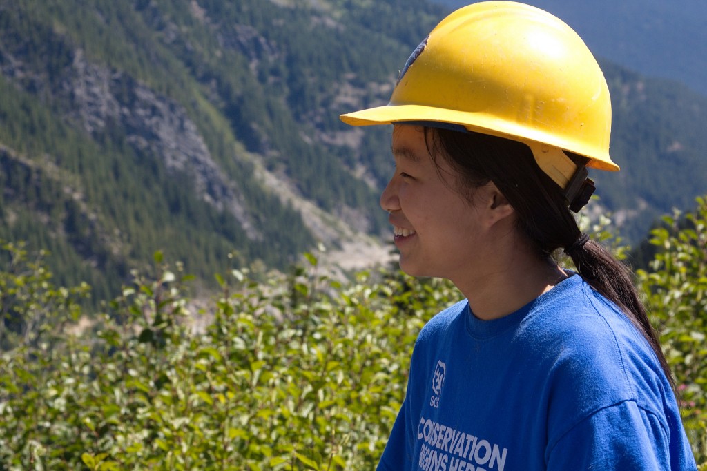 Lady with hard hat in forest
