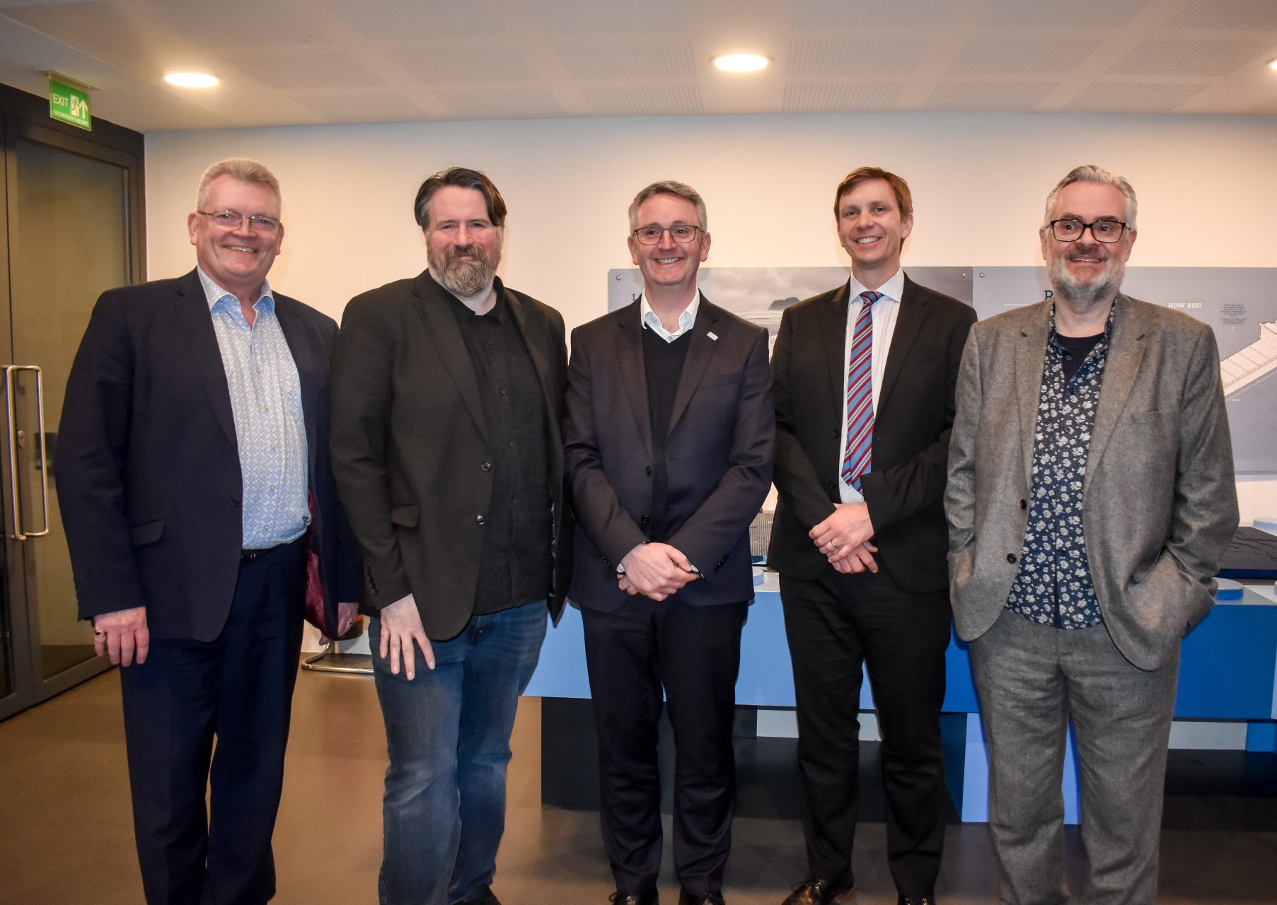 5 men pose for the camera