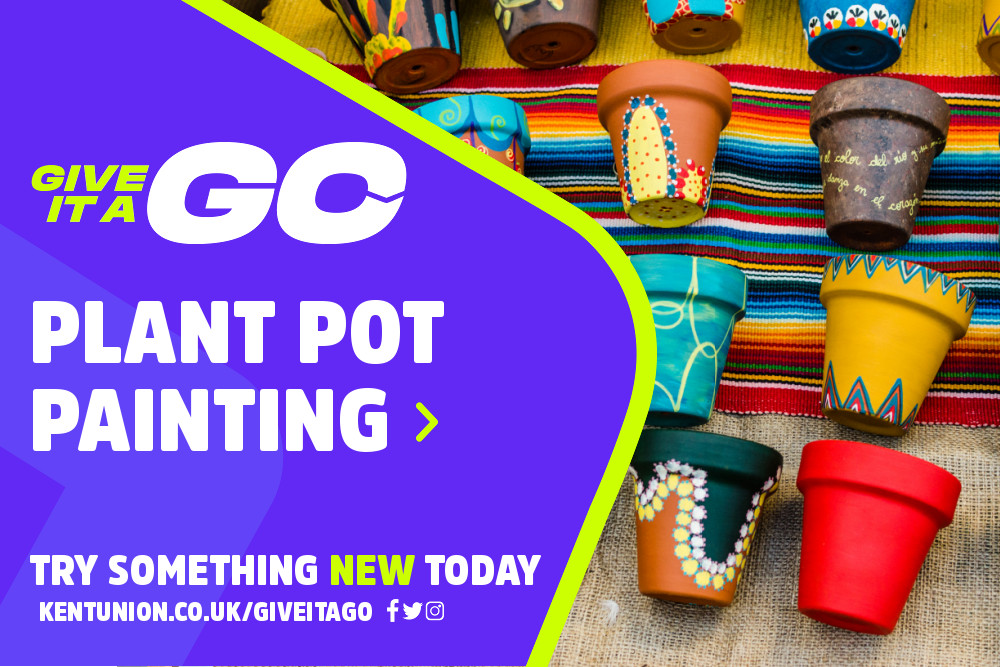 A few lines of plant pots laying on a blanket, each pot has been painted with a graphic or abstract pattern.